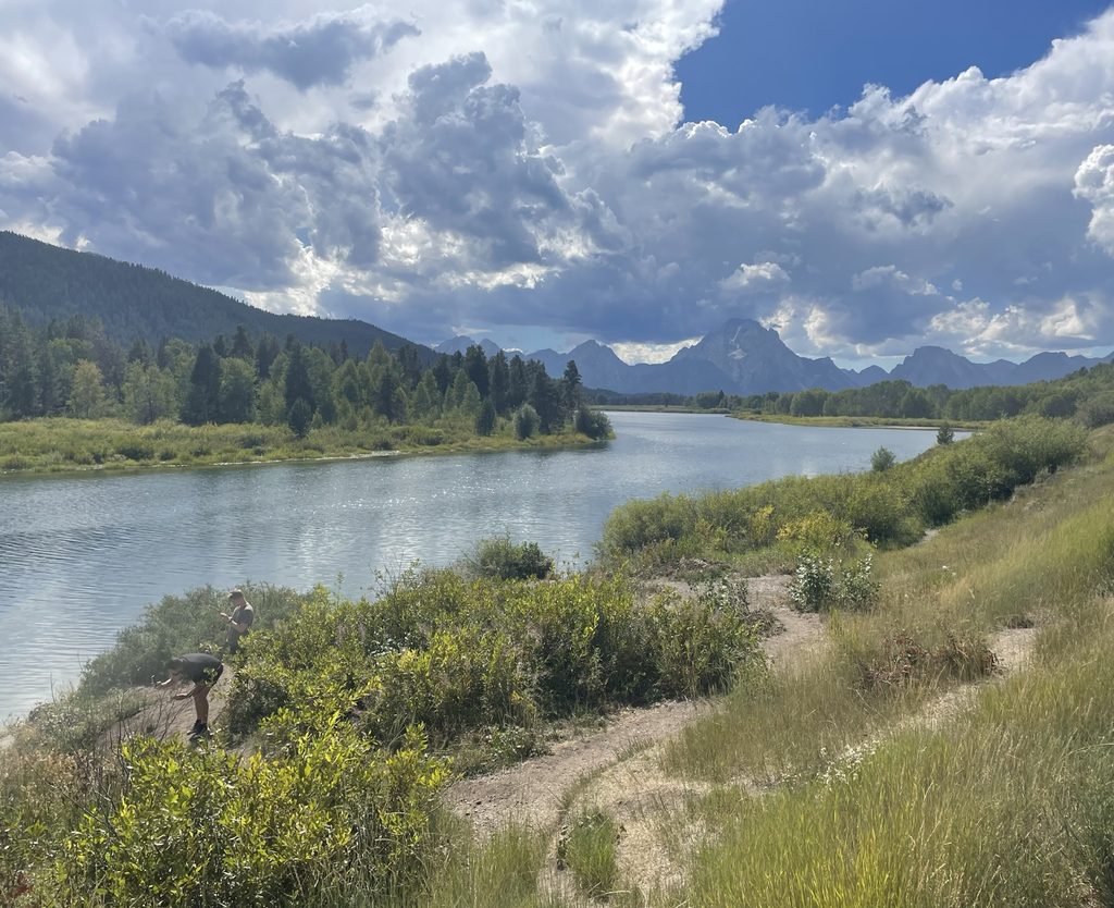 Scenic view of the Snake River and Teton mountain range beneath dramatic clouds at Grand Teton National Park.